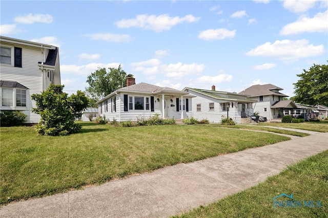 212 18th St, Findlay, OH 45840 - view of front facade with a front lawn and a chimney