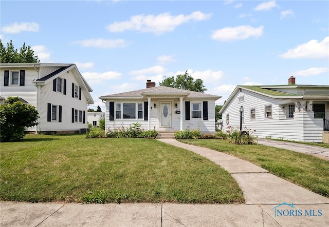 212 18th St, Findlay, OH 45840 - bungalow-style home featuring a front yard and a chimney