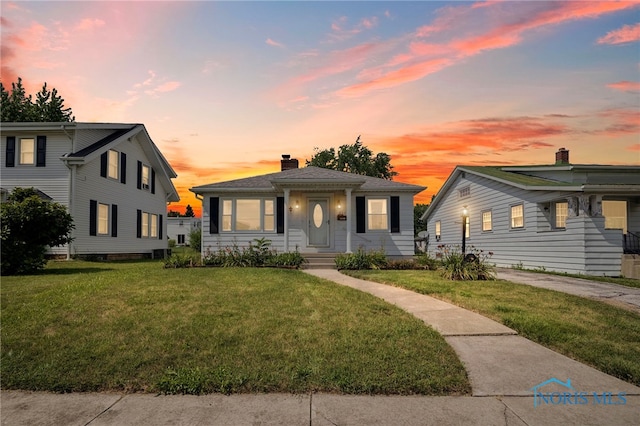 212 18th St, Findlay, OH 45840 - bungalow-style house with a lawn and a chimney