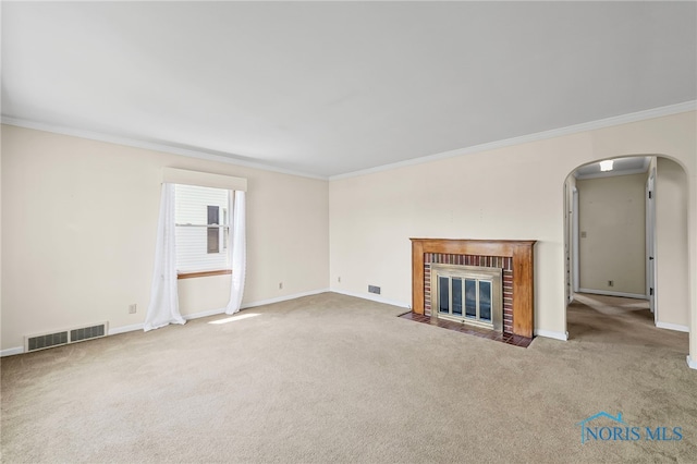 212 18th St, Findlay, OH 45840 - unfurnished living room with carpet, arched walkways, crown molding, and a fireplace