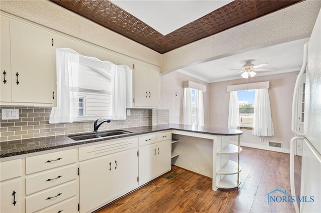 212 18th St, Findlay, OH 45840 - kitchen featuring open shelves, decorative backsplash, hardwood / wood-style floors, ornamental molding, and a peninsula