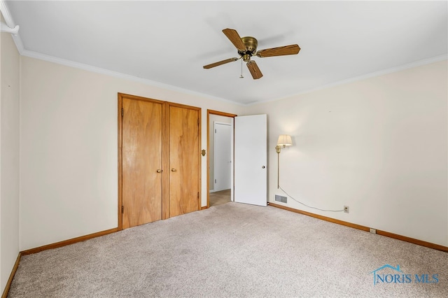 212 18th St, Findlay, OH 45840 - unfurnished bedroom with carpet flooring, ornamental molding, and a ceiling fan