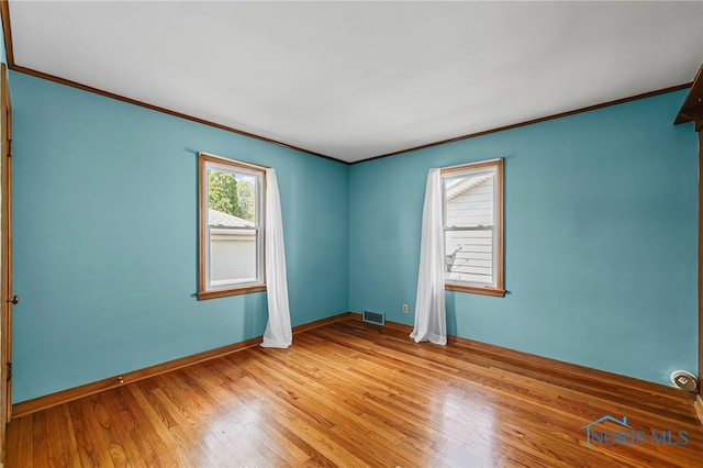 212 18th St, Findlay, OH 45840 - empty room with ornamental molding and light wood finished floors
