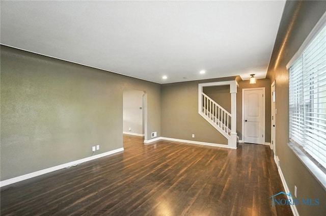 2838 Secor Rd, Toledo, OH 43606 - unfurnished room featuring wood finished floors, stairway, recessed lighting, and arched walkways