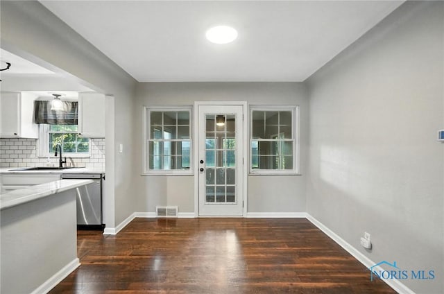 2838 Secor Rd, Toledo, OH 43606 - unfurnished dining area with dark wood-type flooring and baseboards