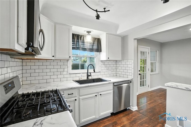 2838 Secor Rd, Toledo, OH 43606 - kitchen with stainless steel appliances, white cabinetry, light stone countertops, and backsplash
