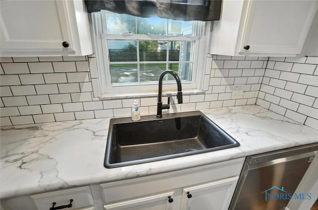 2838 Secor Rd, Toledo, OH 43606 - kitchen featuring stainless steel dishwasher, white cabinetry, and backsplash