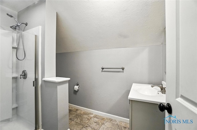 2838 Secor Rd, Toledo, OH 43606 - bathroom featuring a shower stall, vanity, vaulted ceiling, and a textured ceiling