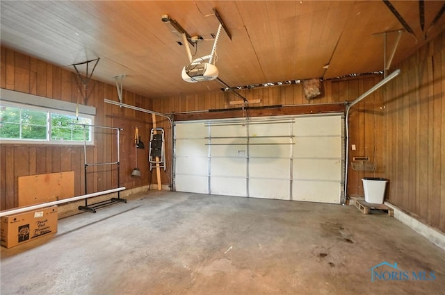 2838 Secor Rd, Toledo, OH 43606 - garage featuring wooden walls, a garage door opener, and wood ceiling