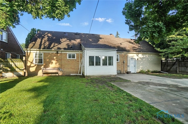 2838 Secor Rd, Toledo, OH 43606 - rear view of house with brick siding, a patio, concrete driveway, and a shingled roof