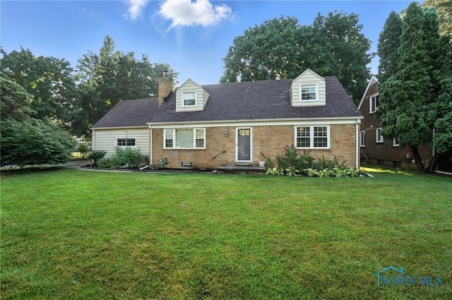 2838 Secor Rd, Toledo, OH 43606 - new england style home with brick siding, a front lawn, and a chimney