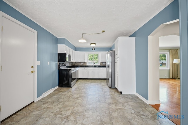 621 Bittersweet Dr, Findlay, OH 45840 - kitchen with stainless steel appliances, white cabinetry, dark countertops, a textured ceiling, and ornamental molding