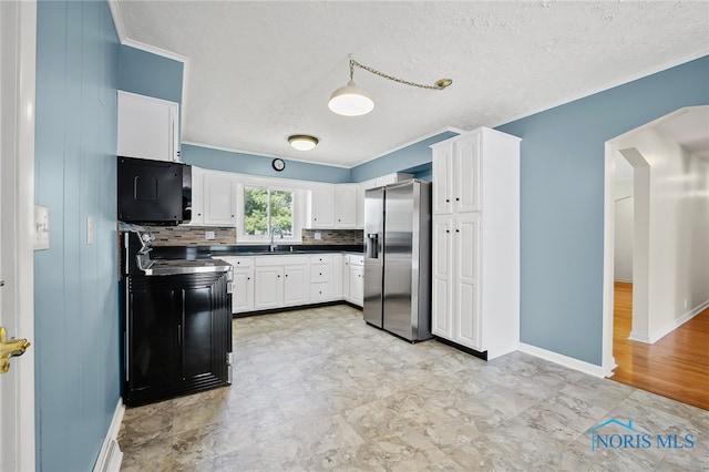 621 Bittersweet Dr, Findlay, OH 45840 - kitchen with stainless steel refrigerator with ice dispenser, black microwave, dark countertops, white cabinets, and a textured ceiling
