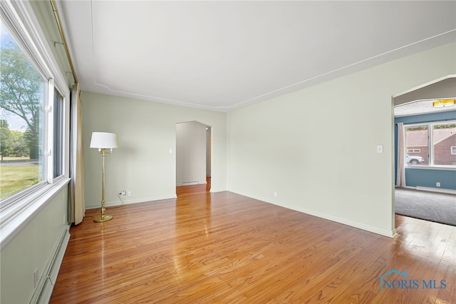 621 Bittersweet Dr, Findlay, OH 45840 - empty room featuring light wood-type flooring and a baseboard heating unit