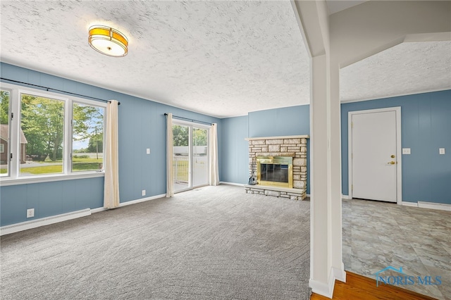 621 Bittersweet Dr, Findlay, OH 45840 - unfurnished living room featuring a textured ceiling and a stone fireplace