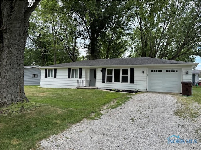 1712 Maumee Dr, Defiance, OH 43512 - ranch-style house with gravel driveway, an attached garage, and a front yard
