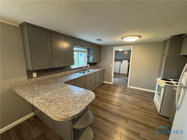 1712 Maumee Dr, Defiance, OH 43512 - kitchen with open shelves, washer and clothes dryer, gray cabinetry, white range with electric stovetop, and a textured ceiling