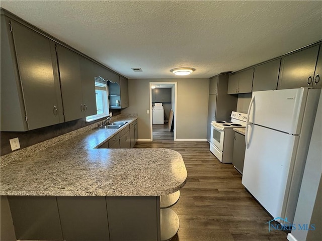 1712 Maumee Dr, Defiance, OH 43512 - kitchen with white appliances, gray cabinets, a textured ceiling, dark wood-style floors, and light countertops