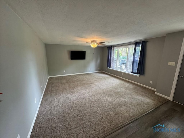 1712 Maumee Dr, Defiance, OH 43512 - unfurnished room with a textured ceiling, a ceiling fan, wood finished floors, and carpet