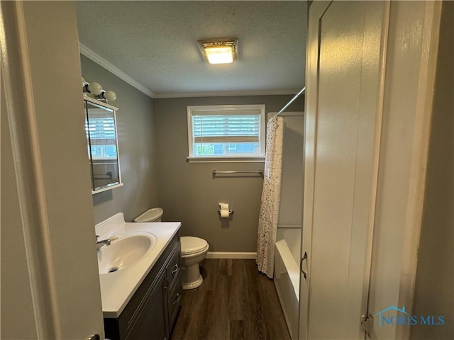 1712 Maumee Dr, Defiance, OH 43512 - full bathroom with wood finished floors, vanity, crown molding, a textured ceiling, and shower / bath combo