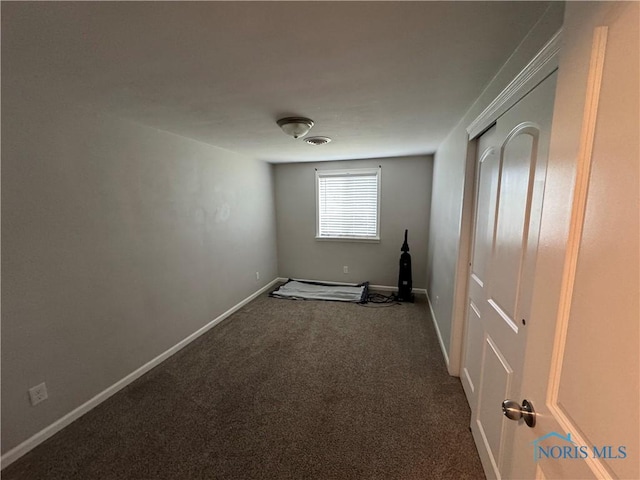 1712 Maumee Dr, Defiance, OH 43512 - empty room with dark carpet and baseboards