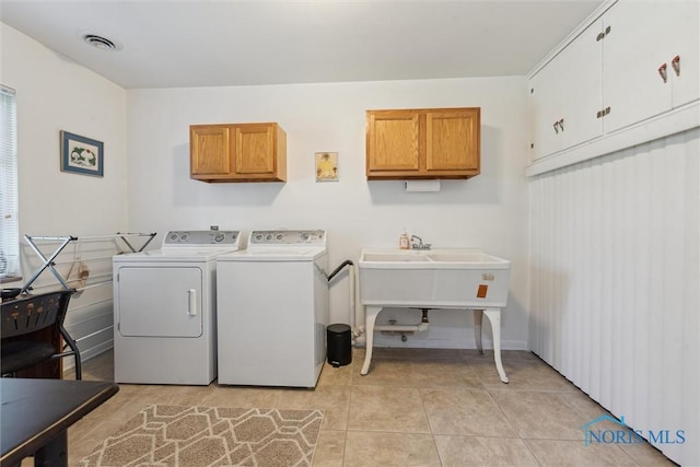 3468 Hughes Blvd, Toledo, OH 43606 - laundry room with cabinet space, independent washer and dryer, and light tile patterned flooring