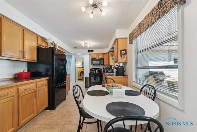 3468 Hughes Blvd, Toledo, OH 43606 - dining area featuring a textured ceiling, light tile patterned floors, and a chandelier