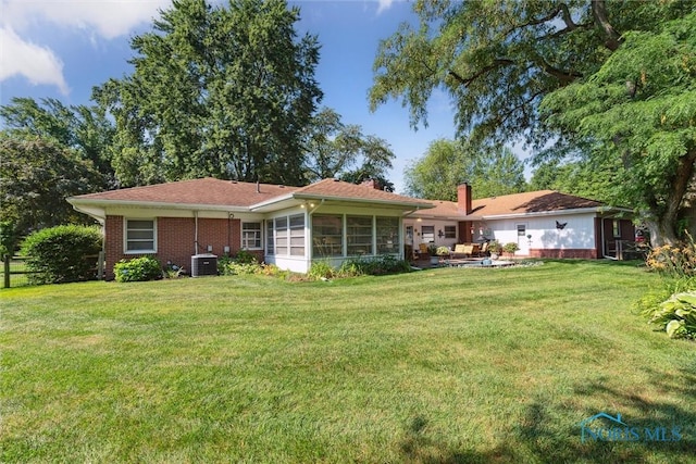 3468 Hughes Blvd, Toledo, OH 43606 - rear view of house featuring a chimney and a sunroom