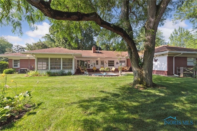 3468 Hughes Blvd, Toledo, OH 43606 - back of house featuring a lawn, a patio, and a chimney