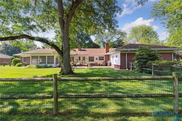 3468 Hughes Blvd, Toledo, OH 43606 - rear view of house featuring brick siding, a chimney, a fenced backyard, and a patio