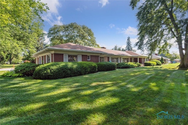 3468 Hughes Blvd, Toledo, OH 43606 - view of front facade with a front lawn and brick siding