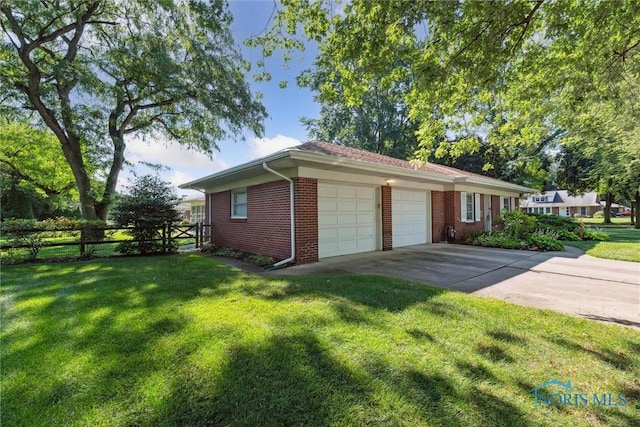 3468 Hughes Blvd, Toledo, OH 43606 - view of home's exterior featuring a garage, brick siding, and concrete driveway