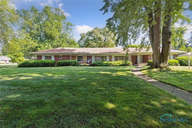3468 Hughes Blvd, Toledo, OH 43606 - ranch-style house with a front lawn and brick siding
