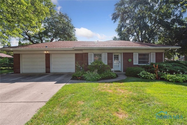 3468 Hughes Blvd, Toledo, OH 43606 - single story home with an attached garage, concrete driveway, brick siding, and a front yard
