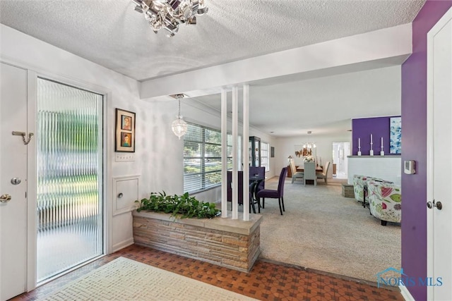 3468 Hughes Blvd, Toledo, OH 43606 - entryway with a chandelier, carpet floors, and a textured ceiling