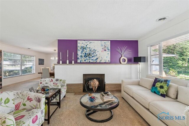 3468 Hughes Blvd, Toledo, OH 43606 - carpeted living room with healthy amount of natural light, a fireplace, and a textured ceiling