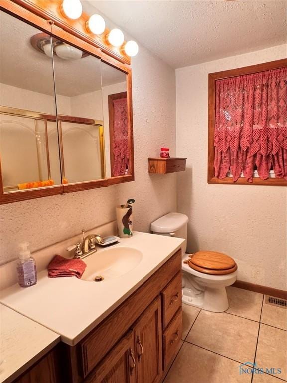 8320 Openlander Rd, Sherwood, OH 43556 - bathroom with vanity, a stall shower, a textured ceiling, tile patterned flooring, and a textured wall