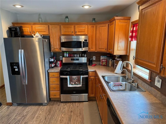 110 Town Line Rd, Bryan, OH 43506 - kitchen featuring appliances with stainless steel finishes, brown cabinets, light countertops, light wood finished floors, and recessed lighting