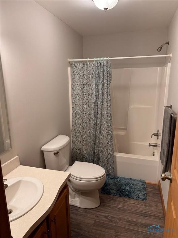 110 Town Line Rd, Bryan, OH 43506 - bathroom featuring vanity, wood finished floors, and shower / bath combo