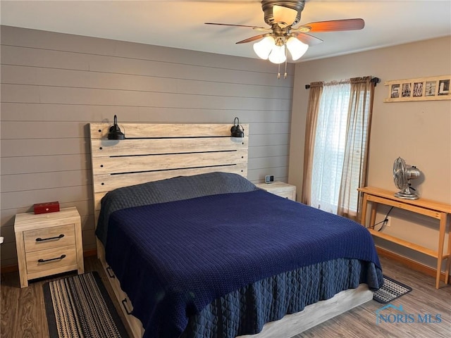 110 Town Line Rd, Bryan, OH 43506 - bedroom with wood finished floors, wood walls, and a ceiling fan