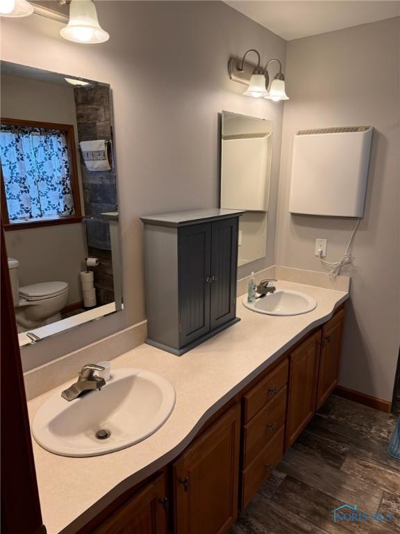 110 Town Line Rd, Bryan, OH 43506 - bathroom featuring double vanity and wood finished floors
