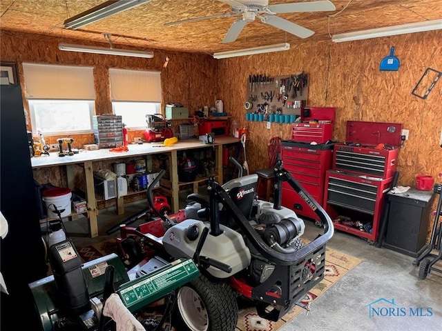 110 Town Line Rd, Bryan, OH 43506 - garage featuring a workshop area, a ceiling fan, and wooden walls