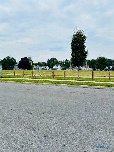 4136 Berwick Ave, Toledo, OH 43612 - view of asphalt road featuring sidewalks and curbs