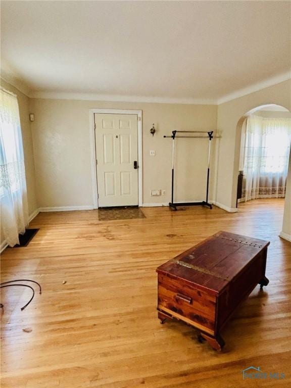 4136 Berwick Ave, Toledo, OH 43612 - living area featuring arched walkways, light wood-style floors, and crown molding