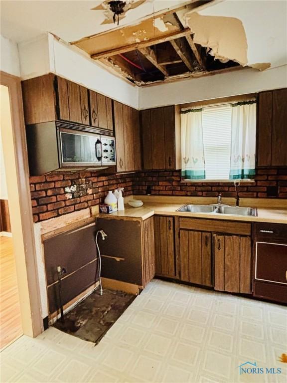 4136 Berwick Ave, Toledo, OH 43612 - kitchen featuring light floors, light countertops, and stainless steel microwave