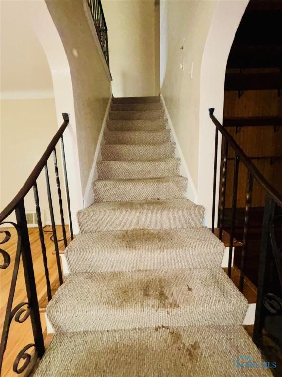 4136 Berwick Ave, Toledo, OH 43612 - staircase with arched walkways and wood finished floors