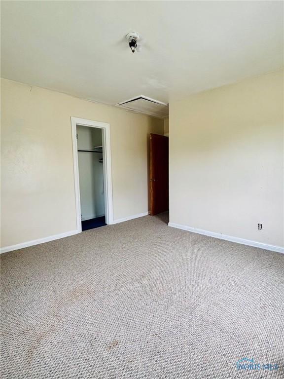 4136 Berwick Ave, Toledo, OH 43612 - unfurnished bedroom with light colored carpet, attic access, and a closet
