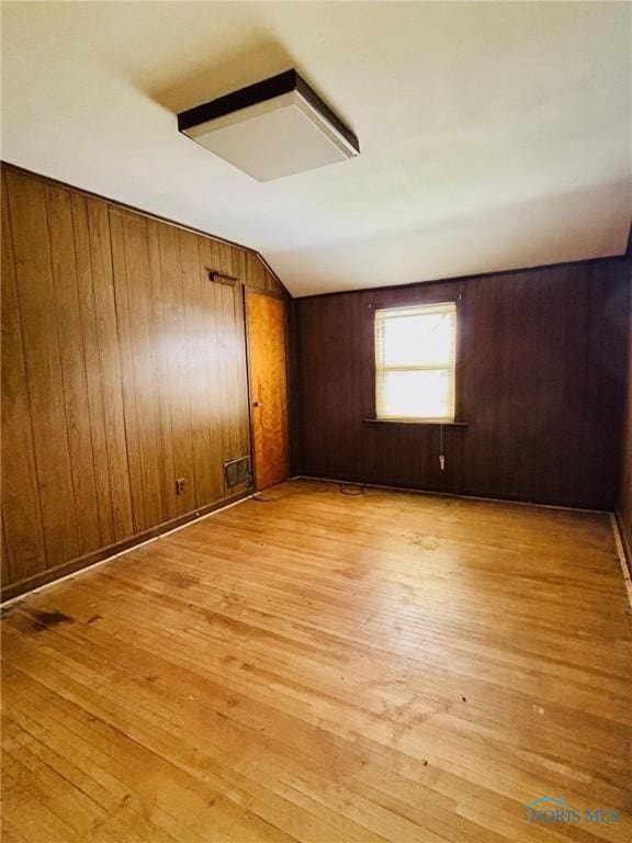 4136 Berwick Ave, Toledo, OH 43612 - empty room featuring light wood-type flooring and wooden walls