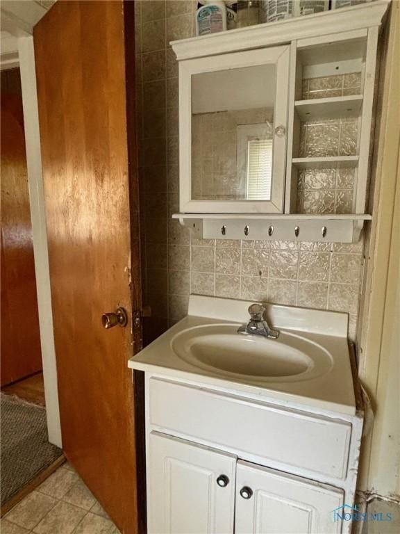 4136 Berwick Ave, Toledo, OH 43612 - bathroom with vanity, backsplash, tile walls, and tile patterned flooring