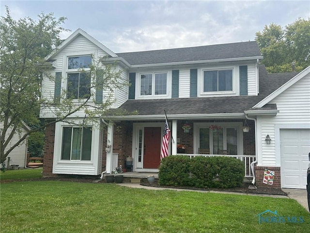 2062 Lexington Dr, Perrysburg, OH 43551 - traditional home featuring roof with shingles, brick siding, a front lawn, and a porch